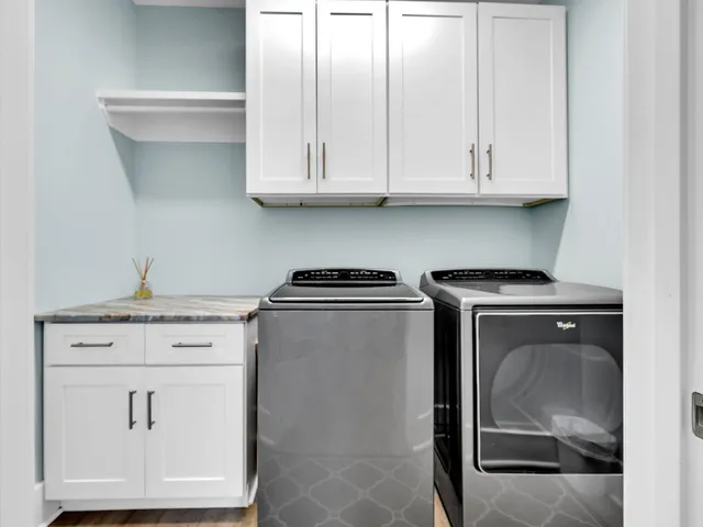 a view of a hallway with furniture and a wooden floor