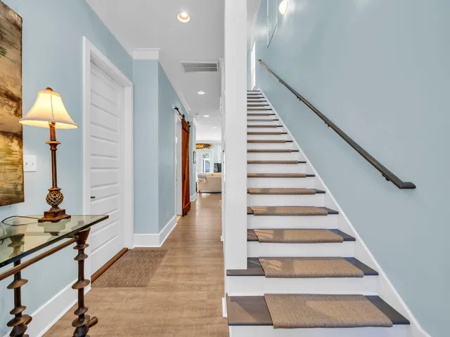a bedroom with a bed a chair and a chandelier