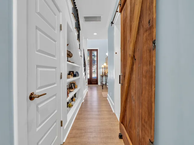 a view of a balcony with wooden floor and outdoor seating