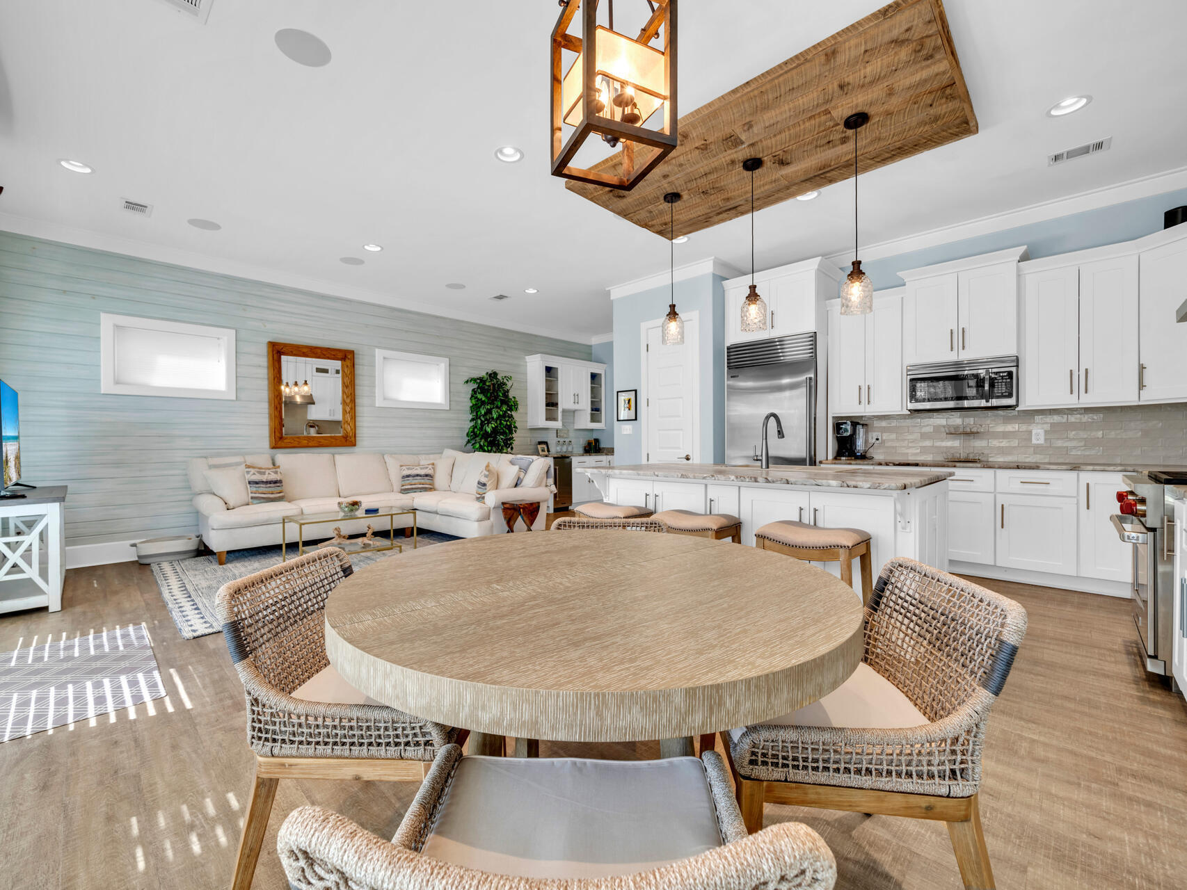 160 Rearden Way Santa Rosa Beach, FL 32459 - Photo 35 of 84 a kitchen with stainless steel appliances kitchen island granite countertop a sink a stove a dining table and chairs with wooden floor