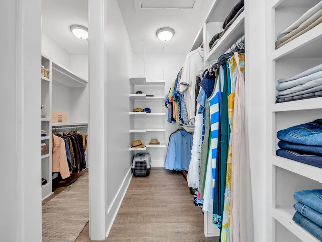 a view of a house with a yard and potted plants