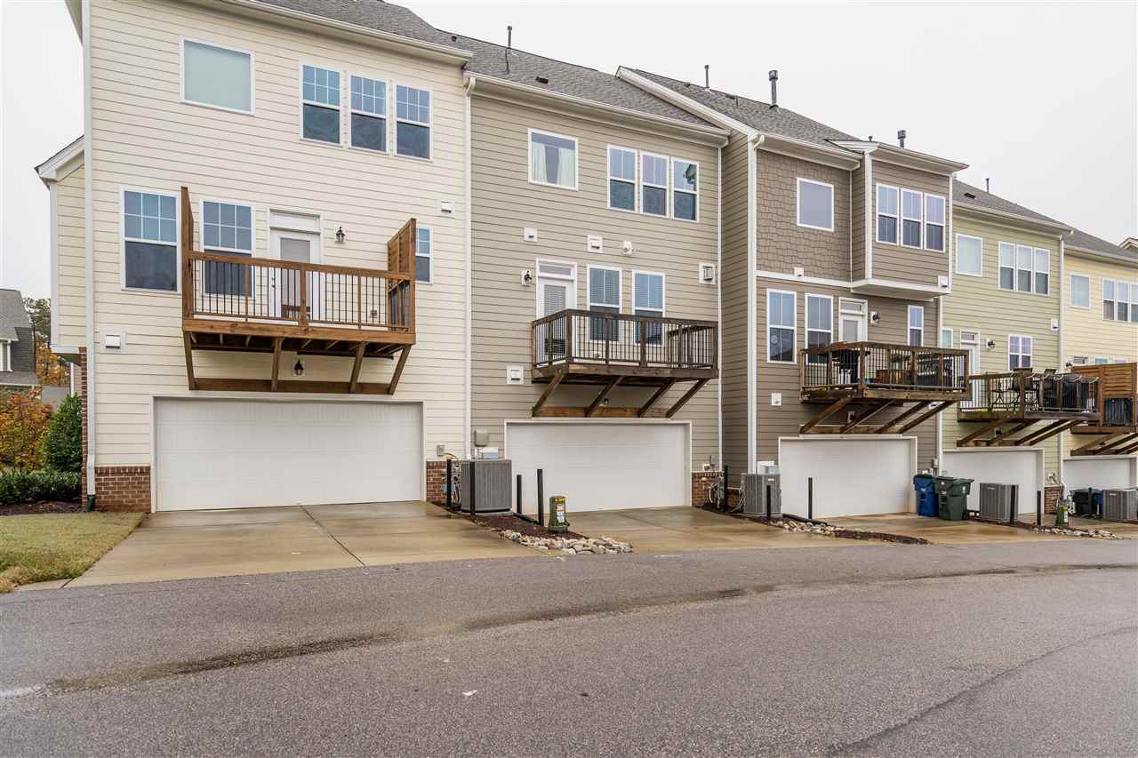 1539 Rodessa Run Raleigh, NC 27607 - Photo 24 of 25 Pull into the private street behind your home to enter the 2 car garage. Enjoy living right next to the pocket park with green space and swings! Rear View