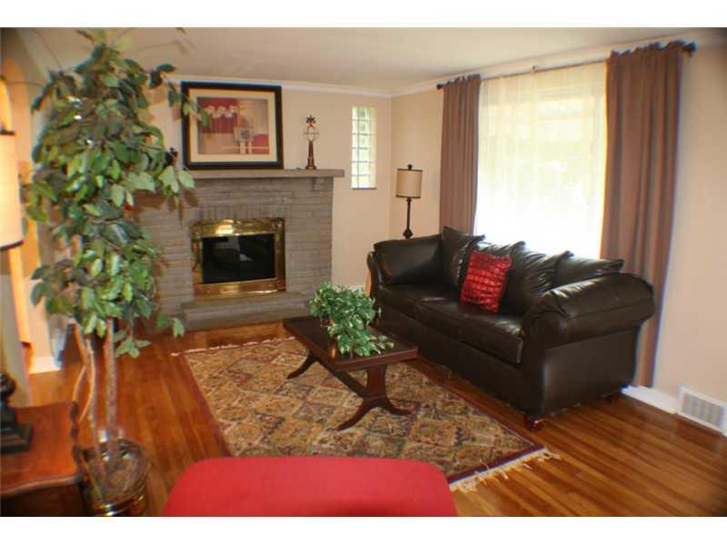 210 Siebert Road Pittsburgh, PA 15237 - Photo 5 of 25 Living Room. The Nicely Sized Living Room is bright and Neutral and boasts a Stone Fireplace.