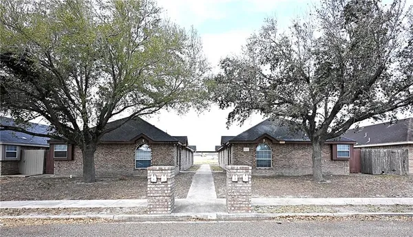 a view of a house with a yard covered in snow