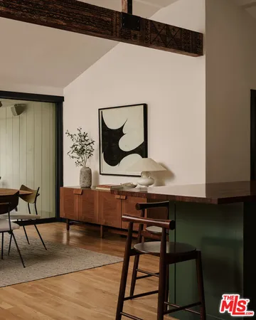 a view of a room with furniture and wooden floor