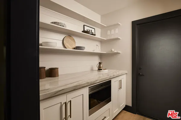 a kitchen with stainless steel appliances granite countertop a sink and a microwave