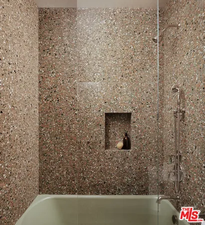 a bathroom with a shower and a sink