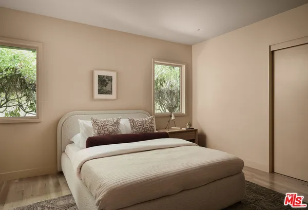 a bedroom with a bed and a window