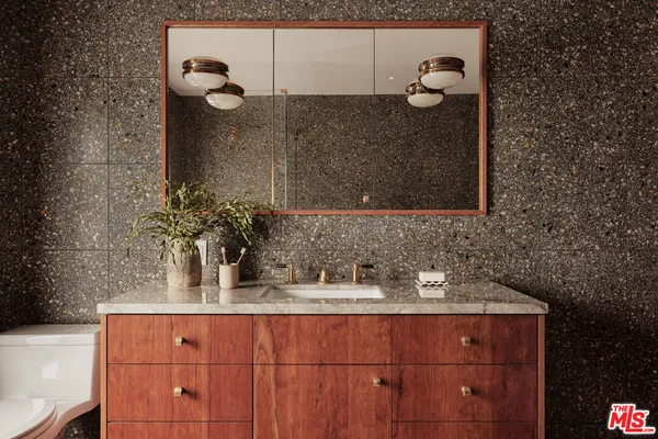 a bathroom with a sink and mirror