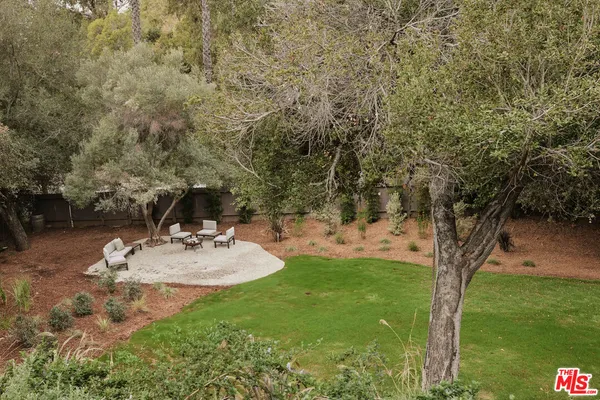 a view of backyard with a garden and trees
