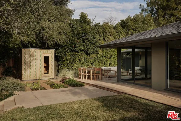 a view of a patio with table and chairs and potted plants