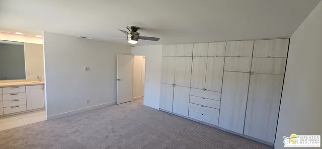 a view of an empty room with a cabinet