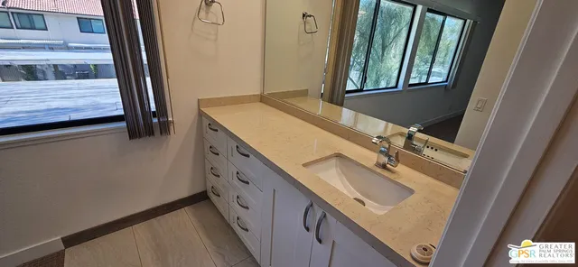 a bathroom with a double vanity sink and mirror