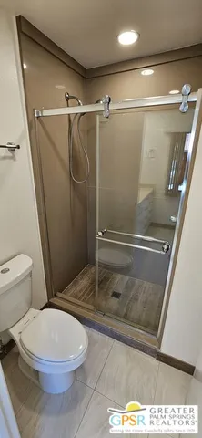 a bathroom with a toilet and a shower