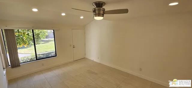 a view of an empty room with a window