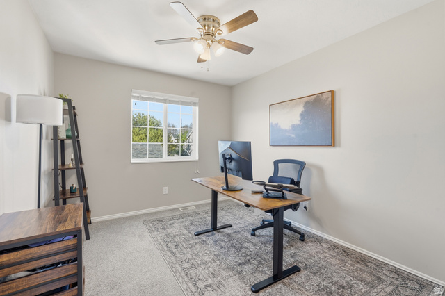 99 Penhurst Place Logan, UT 84341 - Photo 20 of 34 Bright room featuring a window with grid inserts, light gray wall paint, and a ceiling fan with light fixture