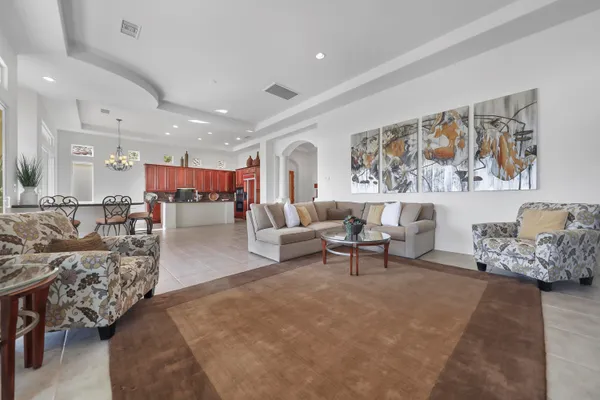 a living room with furniture and painting on the wall