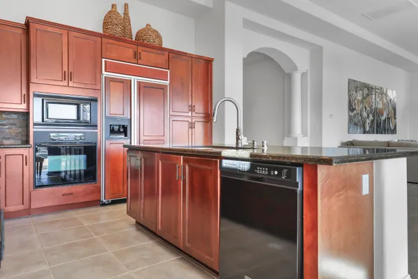 a kitchen with stainless steel appliances granite countertop a refrigerator and a sink