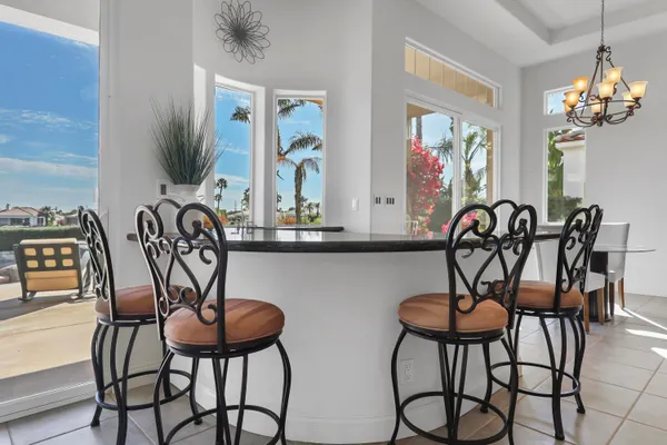 a view of a dining room with furniture and chandelier