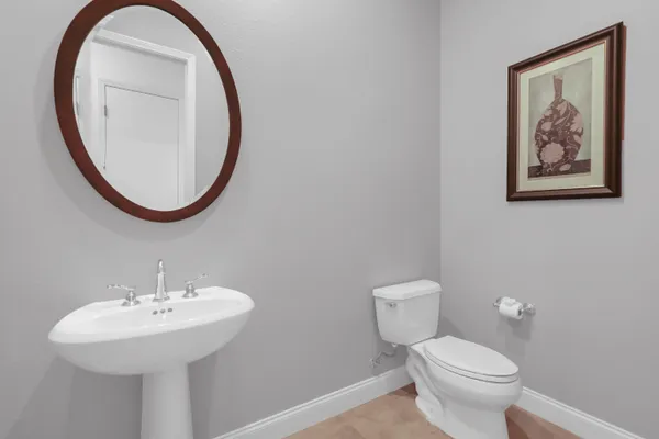 a bathroom with a toilet a sink and a mirror