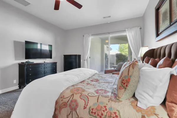 a bedroom with a bed and a flat screen tv