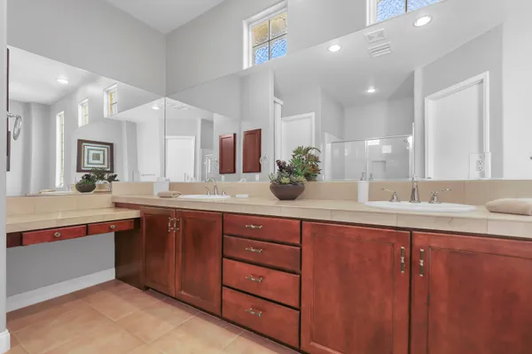 a spacious bathroom with a granite countertop sink and mirror