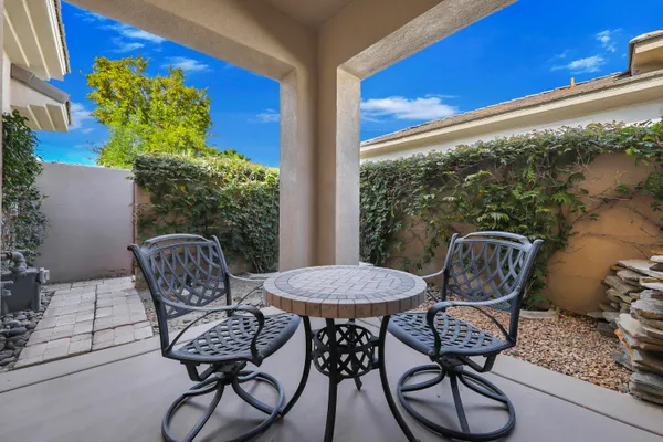 a view of a chairs and table in patio