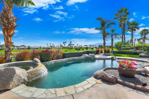 a view of a lake with a table and chairs