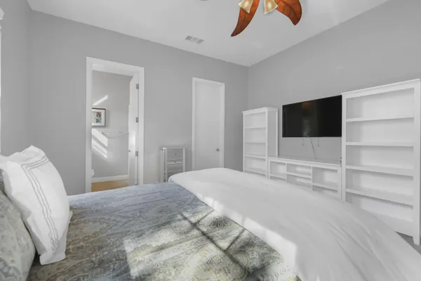 a bedroom with a bed and a flat screen tv