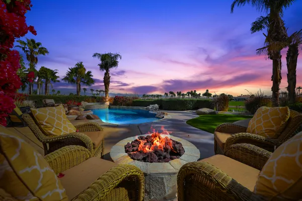 a view of a patio with couches chairs and a potted plant