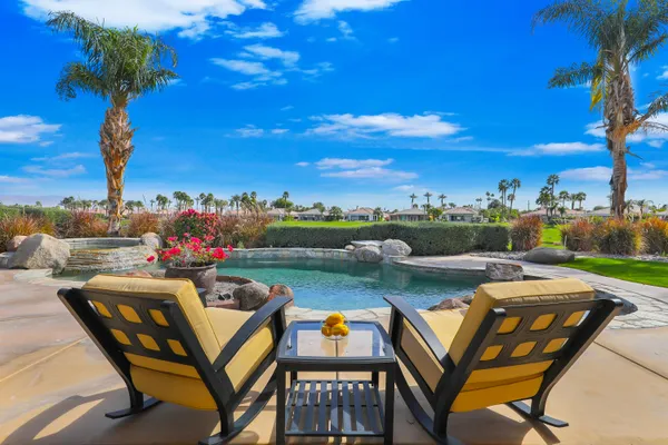 a view of swimming pool and outdoor seating