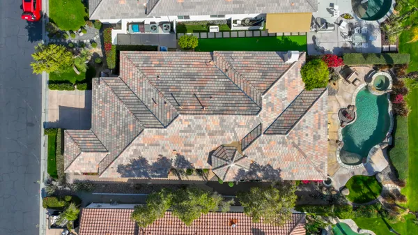 a view of a house with swimming pool and sitting area