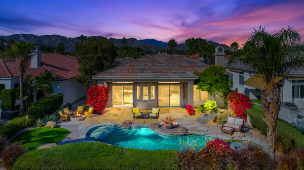 a view of a backyard with wooden fence