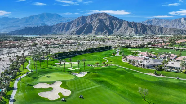 a view of a lake with couches chairs and a table
