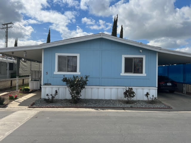 900 East Rankin Road, Unit 5 Tulare, CA 93274 - Photo 2 of 26 a front view of a house with a yard