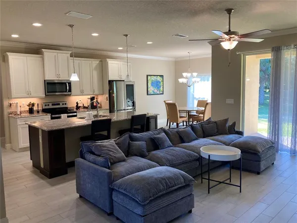 a kitchen with stainless steel appliances granite countertop a refrigerator and a sink