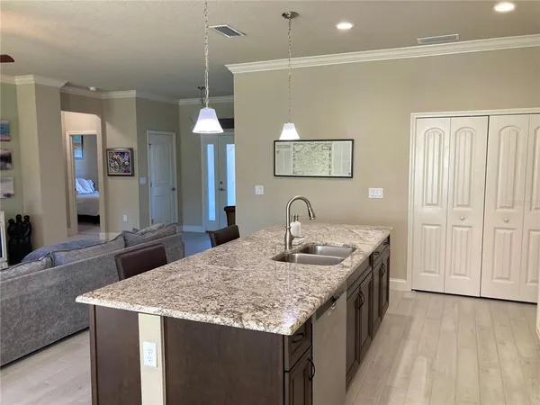 a view of a dining room with furniture a chandelier and wooden floor