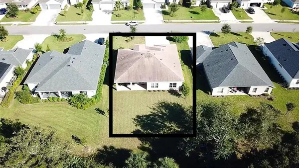 an aerial view of a house with a yard basket ball court and outdoor seating