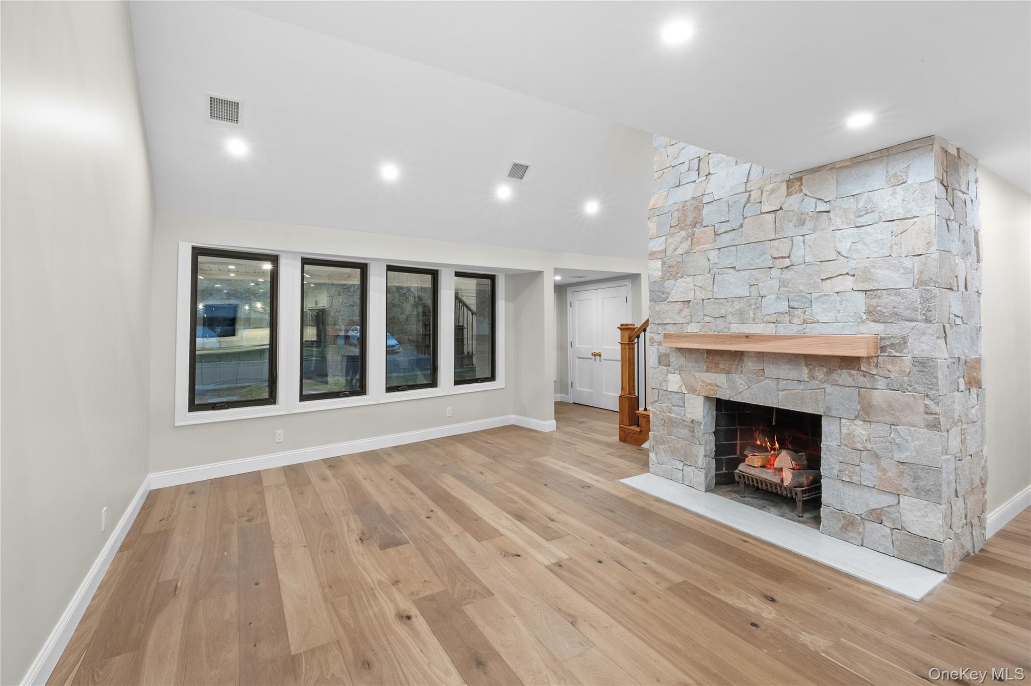 11 Ranch Place Merrick, NY 11566 - Photo 11 of 40 a view of an empty room with wooden floor fireplace and a window