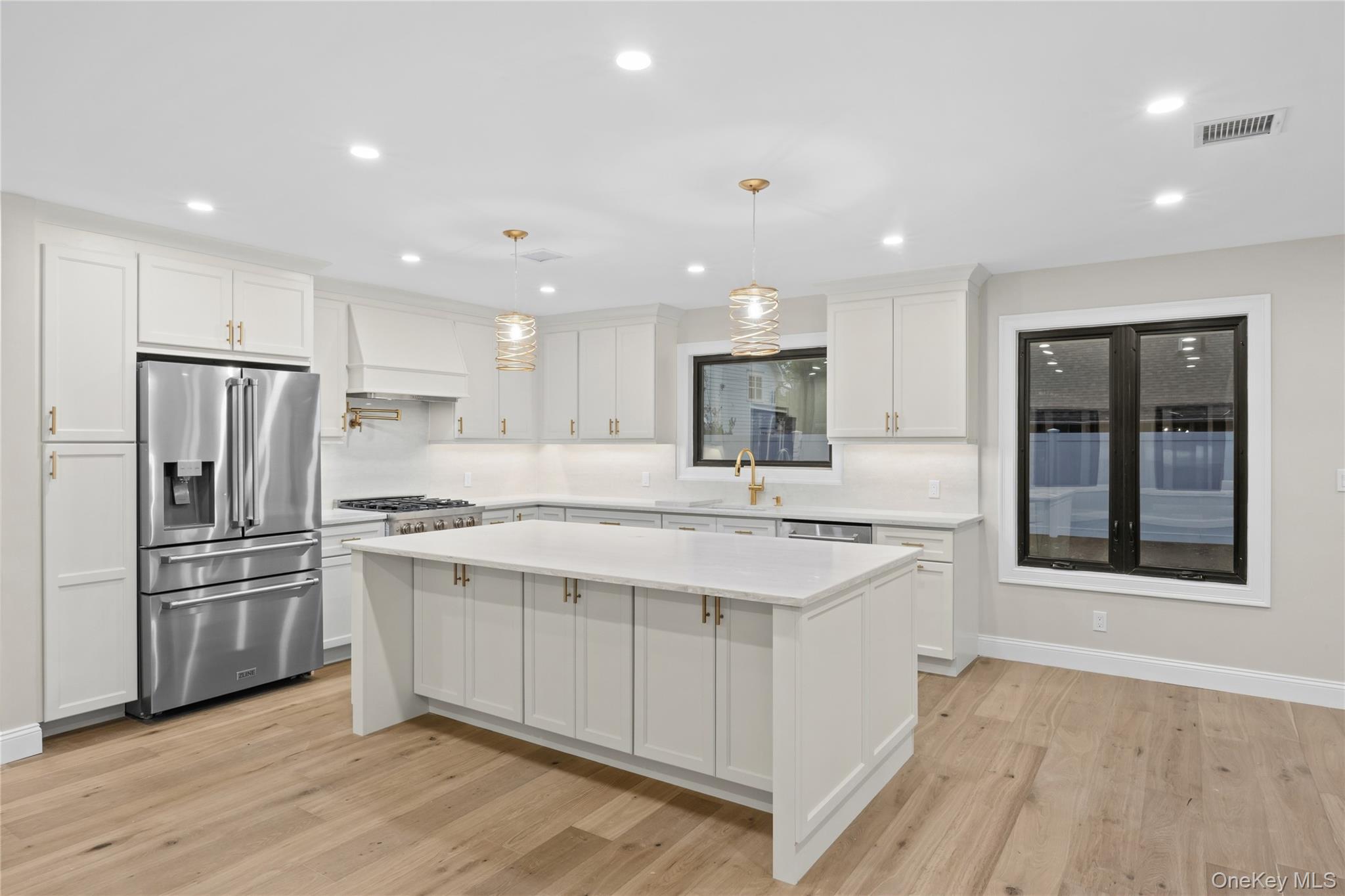11 Ranch Place Merrick, NY 11566 - Photo 16 of 40 a kitchen with stainless steel appliances a sink stove and refrigerator