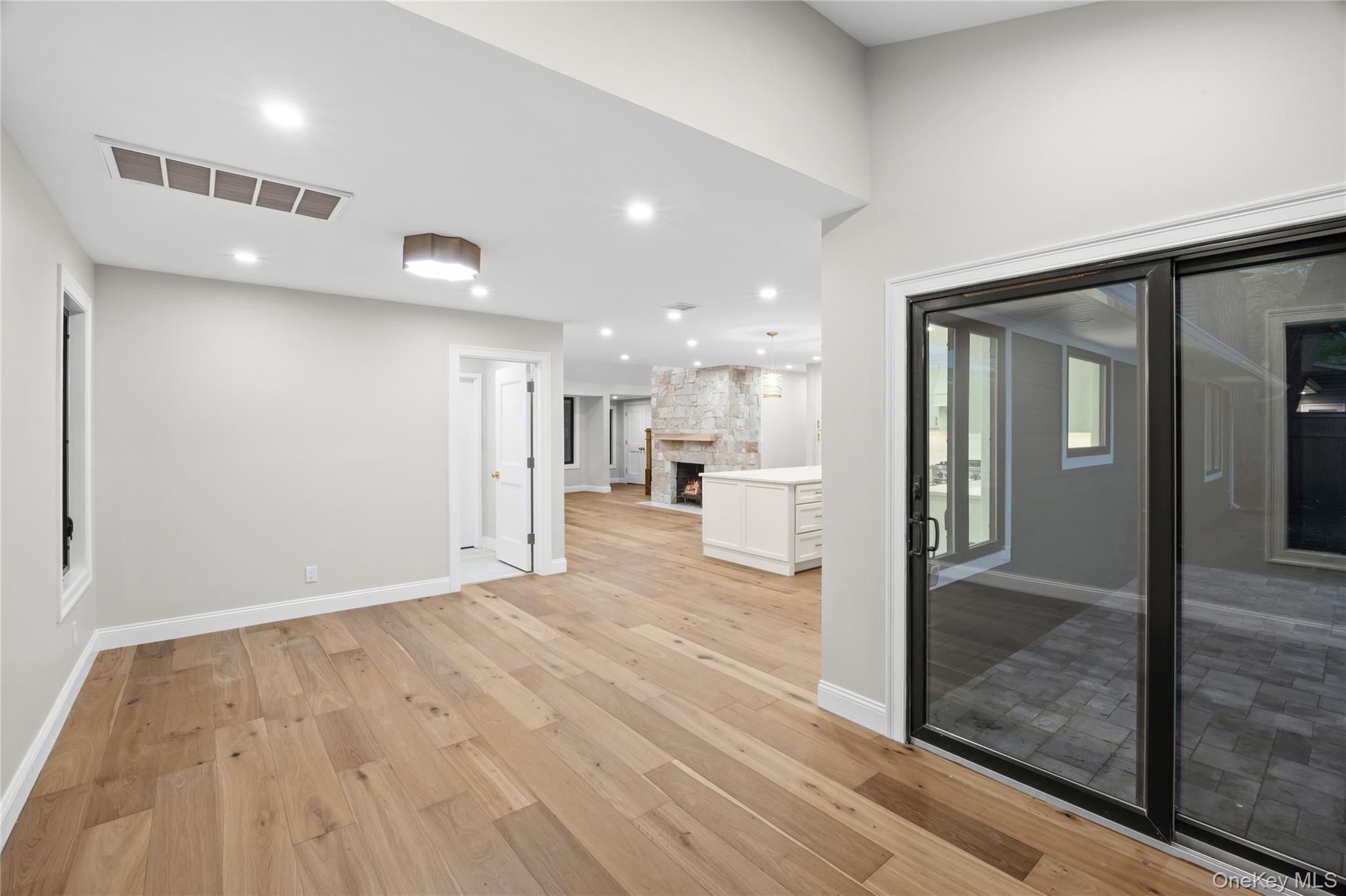 11 Ranch Place Merrick, NY 11566 - Photo 18 of 40 a view of a hallway with wooden floor and a living room