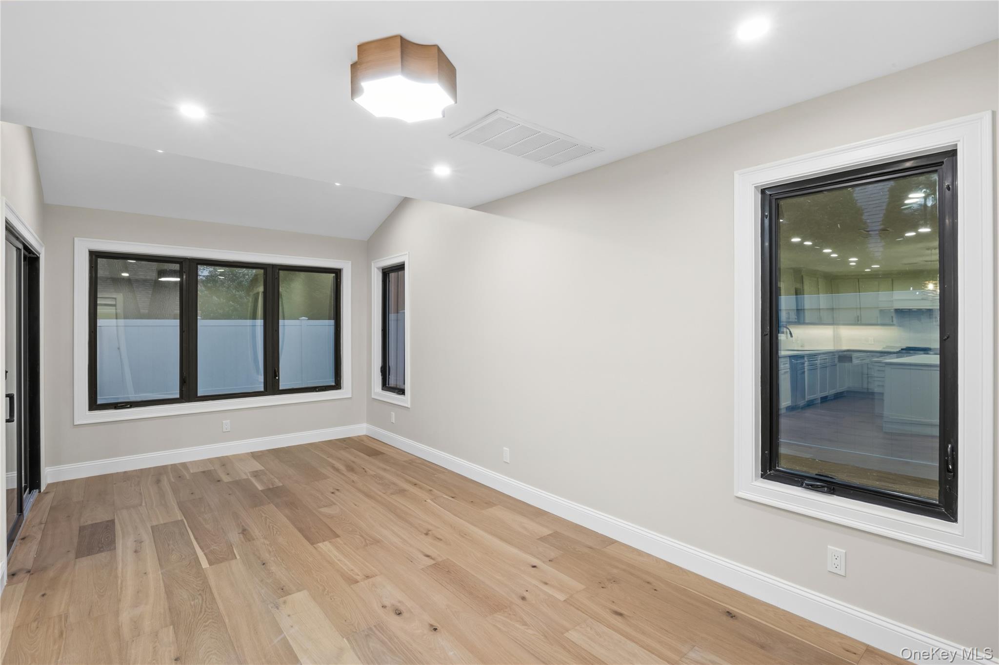 11 Ranch Place Merrick, NY 11566 - Photo 20 of 40 an empty room with wooden floor and windows