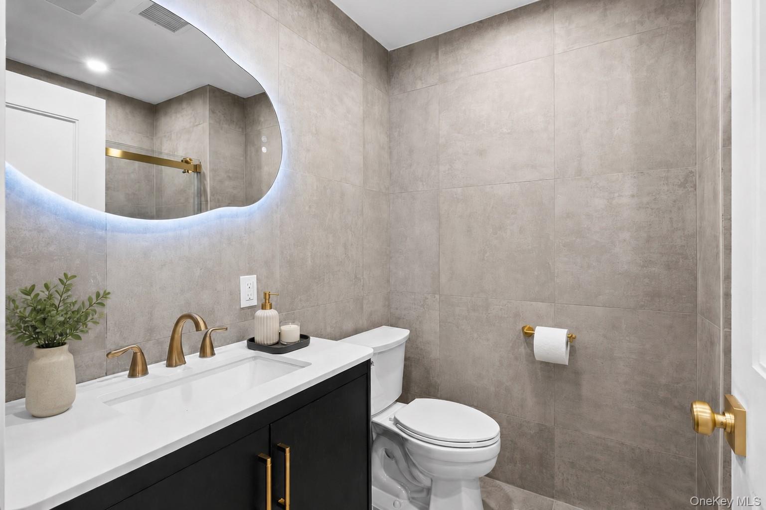 11 Ranch Place Merrick, NY 11566 - Photo 22 of 40 a bathroom with a toilet sink and mirror