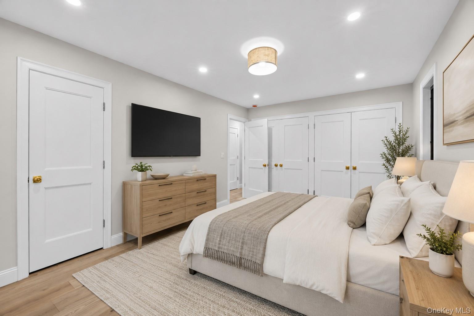 11 Ranch Place Merrick, NY 11566 - Photo 24 of 40 a bedroom with a bed and a flat screen tv