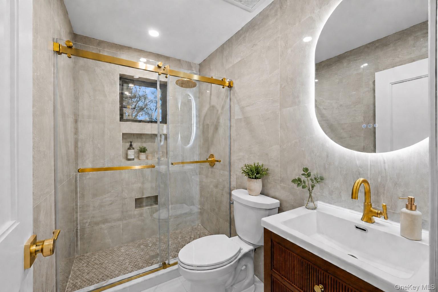11 Ranch Place Merrick, NY 11566 - Photo 29 of 40 a bathroom with a sink mirror toilet and shower