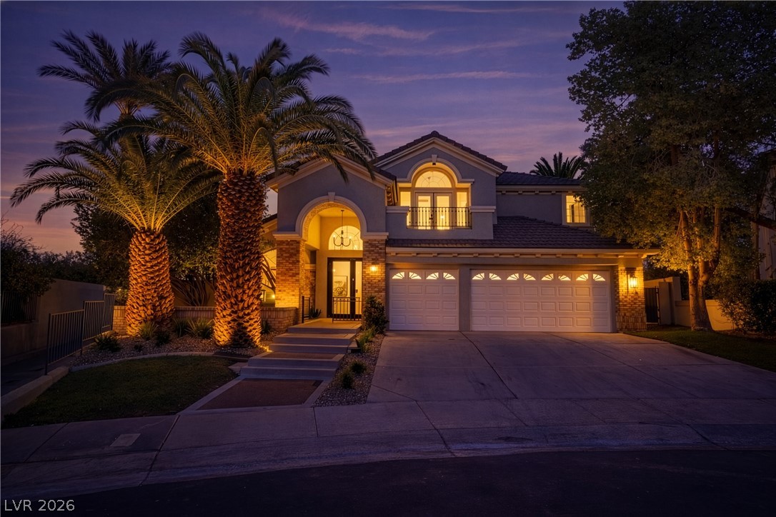 8800 Lusso Las Vegas, NV 89134 - Photo 5 of 85 Mediterranean / spanish house featuring concrete driveway, stucco siding, and a tiled roof