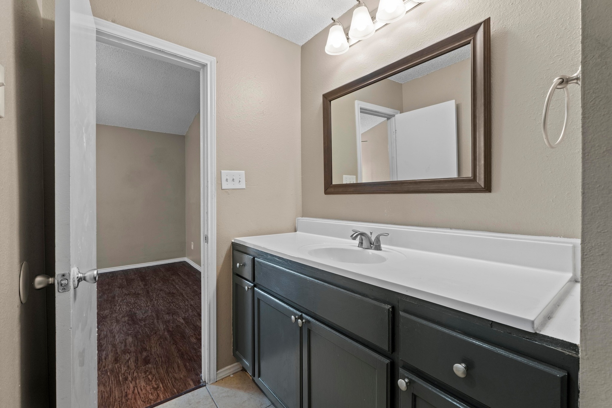 4208 Duval Road, Unit C Austin, TX 78759 - Photo 16 of 28 Bathroom featuring vanity and a textured ceiling