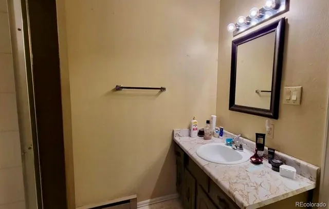 a bathroom with a sink vanity and a mirror