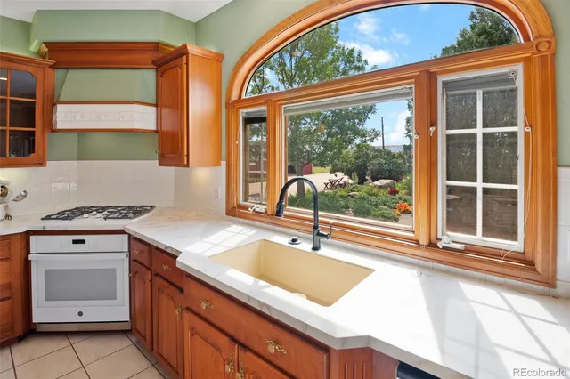 a kitchen with a sink and a large window