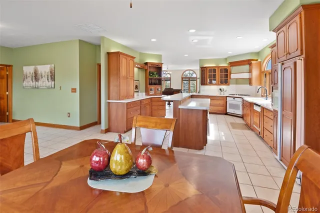 a dining hall with stainless steel appliances furniture and large windows